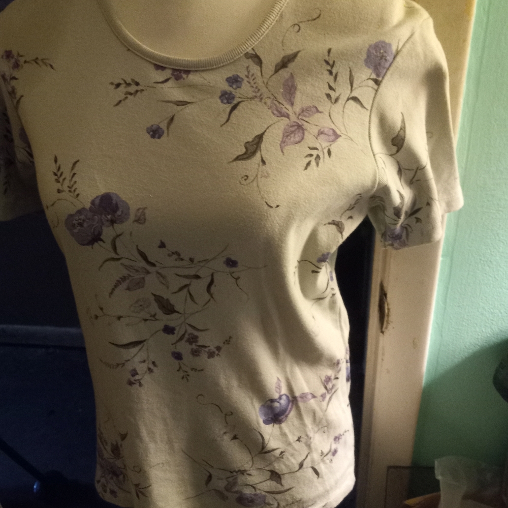 Not new,never worn light blue knit top with floral pattern print size medium.